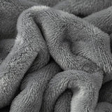 Tissu polaire et doux de notre plaid gris fonce pour canape