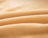 Tissu elastique et doux de notre housse de canape en velours beige