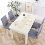 4 housses de chaises en tissu bleu gris dans une decoration de salle a manger