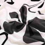 Textile extensible pour housse de chaise fleurie blanc noir